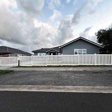 A stylish white slat fence built by Fence NZ, enhancing both the privacy and curb appeal of an Auckland home.