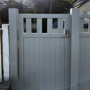 Fence NZ project: A matching pedestrian gate alongside a main vehicle gate, a complete fencing solution for a home.