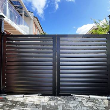 A stylish double swing gate built by Fence NZ, enhancing the curb appeal of a modern Auckland home.