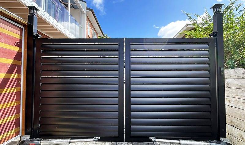 A stylish double swing gate built by Fence NZ, enhancing the curb appeal of a modern Auckland home.