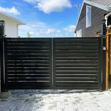 Professional swing gate installation by Fence NZ, showcasing a high-quality gate system for a property in Auckland.