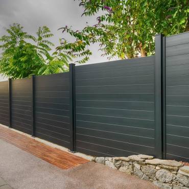Fence NZ: A modern black aluminum fence and gate providing security and style for a residential home.