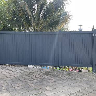 Fence NZ: A modern black aluminum fence and gate providing security and style for a residential home.