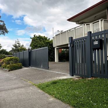A stylish black sliding gate built by Fence NZ, enhancing both the security and curb appeal of an Auckland home.